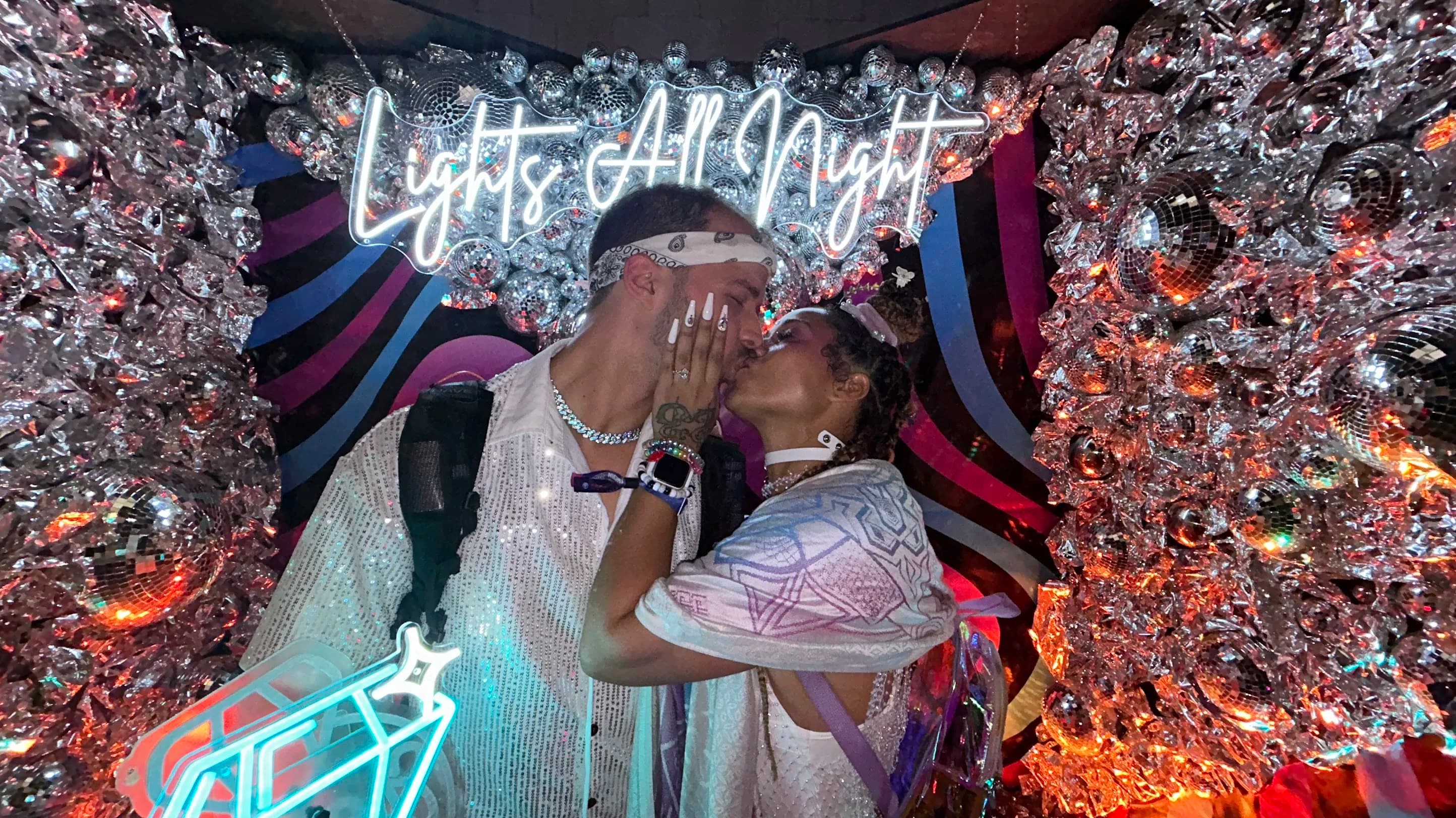 Sean and Eva kissing surrounded the disco balls and mirrors with "Lights All Night" in the background at LAN 2024
