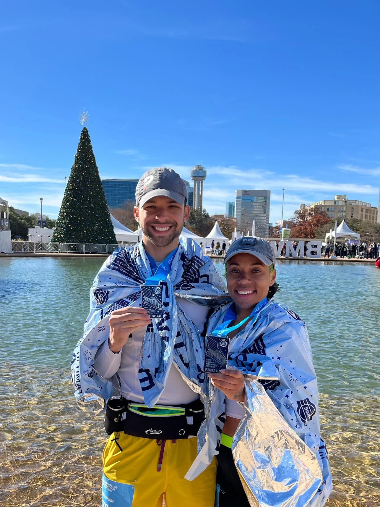 Sean and Eva holding medals from the marathon